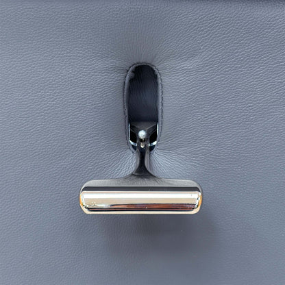 Close-up of the chrome recline handle on the side of the Elm petrol blue leather swivel recliner chair