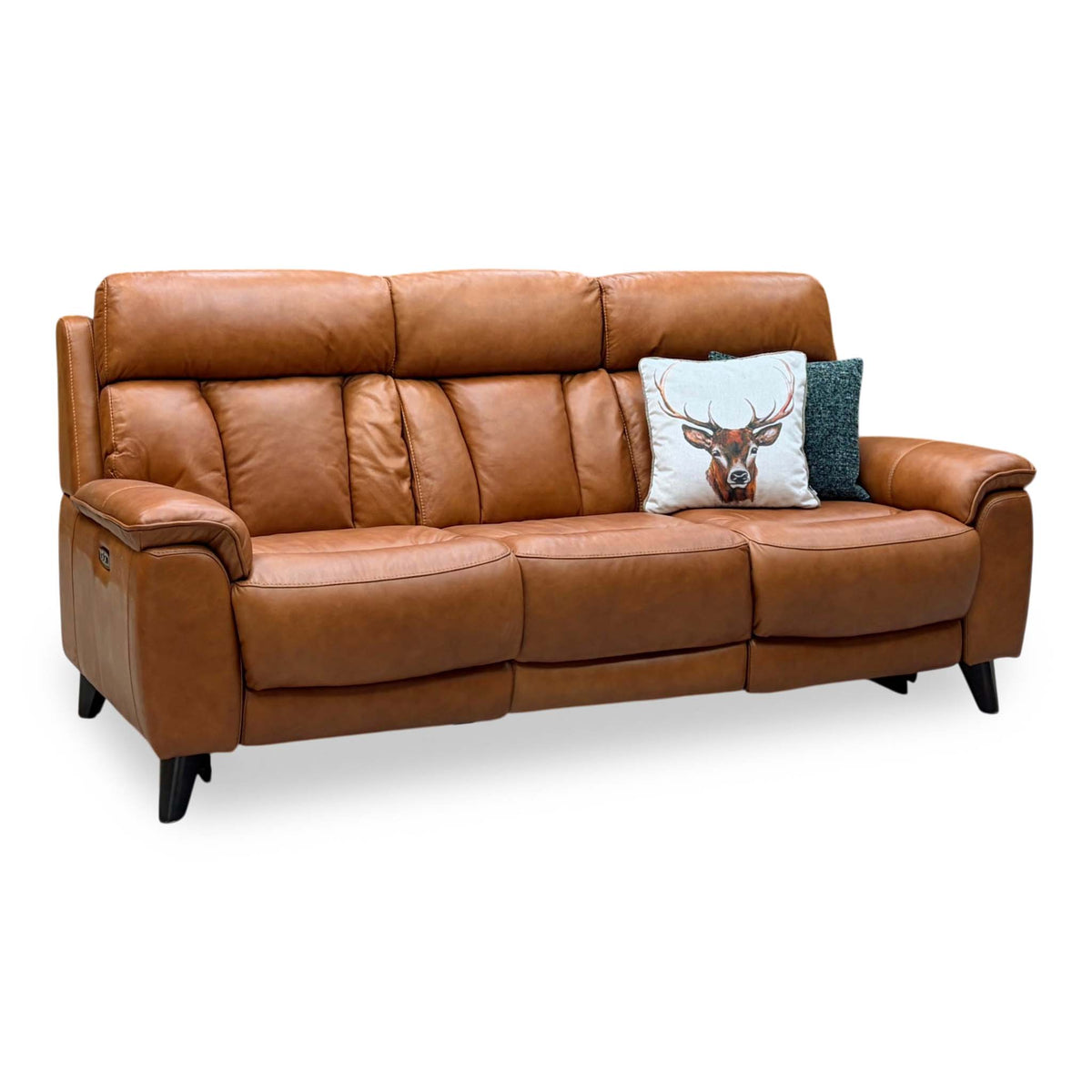 Dreamer saddle brown leather 3 seater power recliner sofa, angled view with a stag print cushion