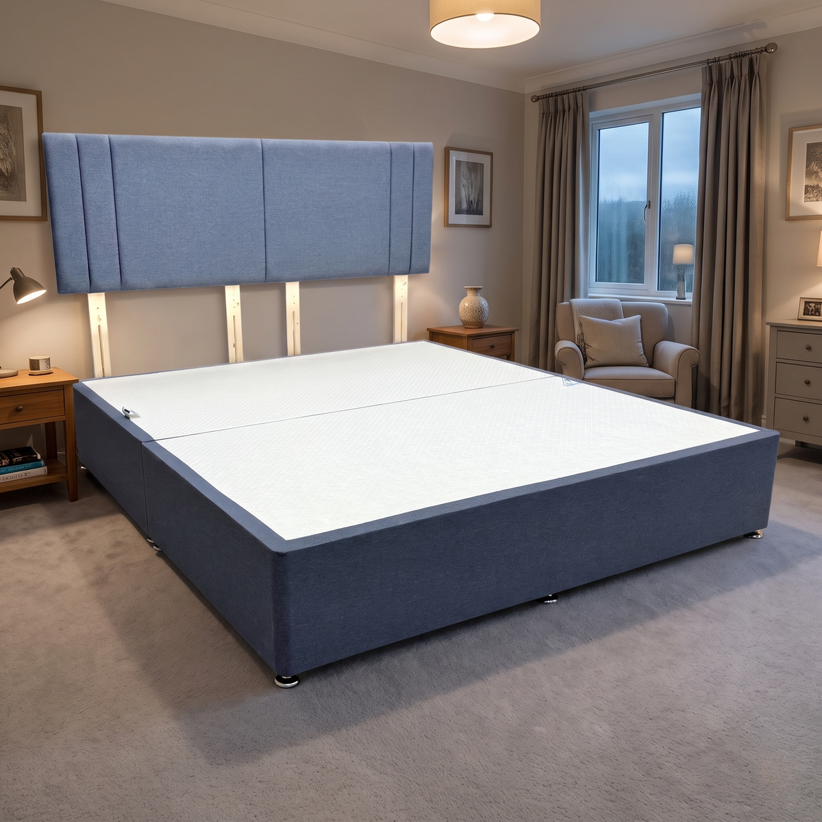 Nelson denim blue fabric strutted headboard and super king divan base in a bedroom with an armchair