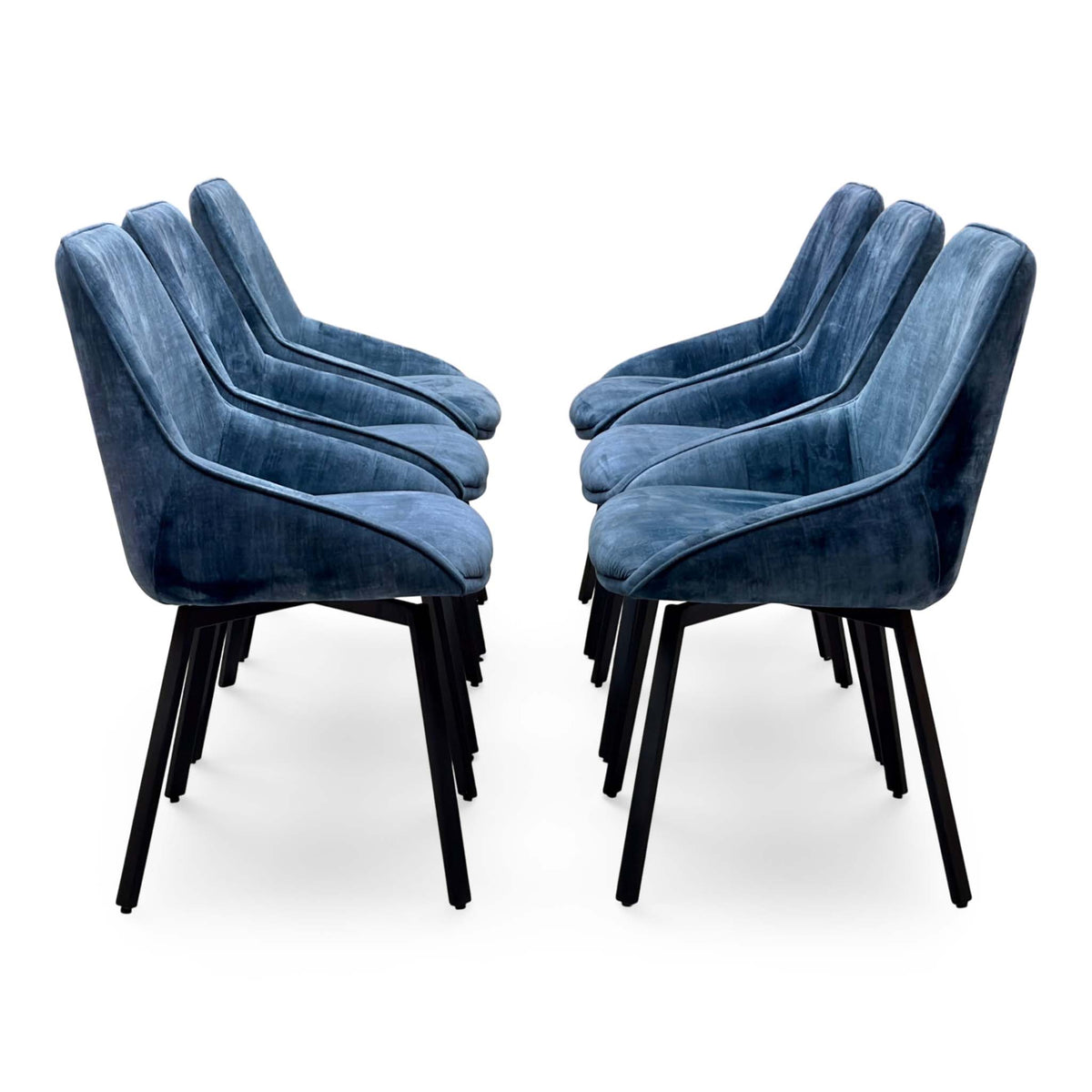 Side view of the Veja heritage blue velvet set of 6 swivel dining chairs arranged in two facing rows