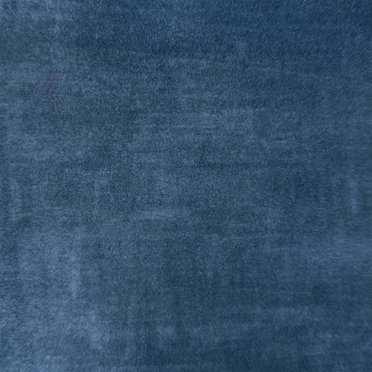 Close-up of the heritage blue velvet fabric used on the Veja swivel dining chairs