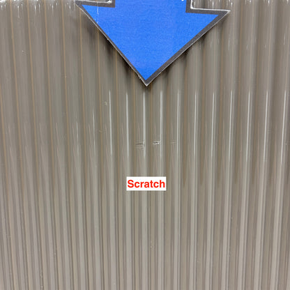 Close-up of a small scratch on the fluted grey door of the Ivy sideboard, marked with an arrow