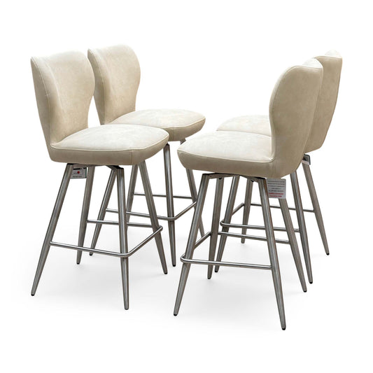Elegante ivory white faux leather set of 4 swivel bar stools, angled view with brushed steel legs and footrests