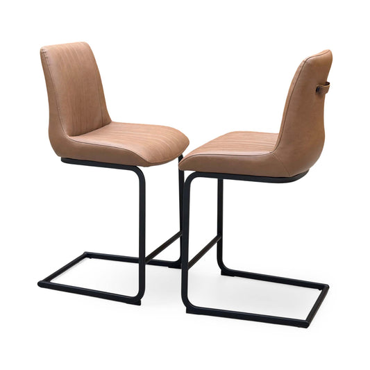Bodahl Terra cognac brown faux leather pair of cantilever bar stools on black frames, angled view