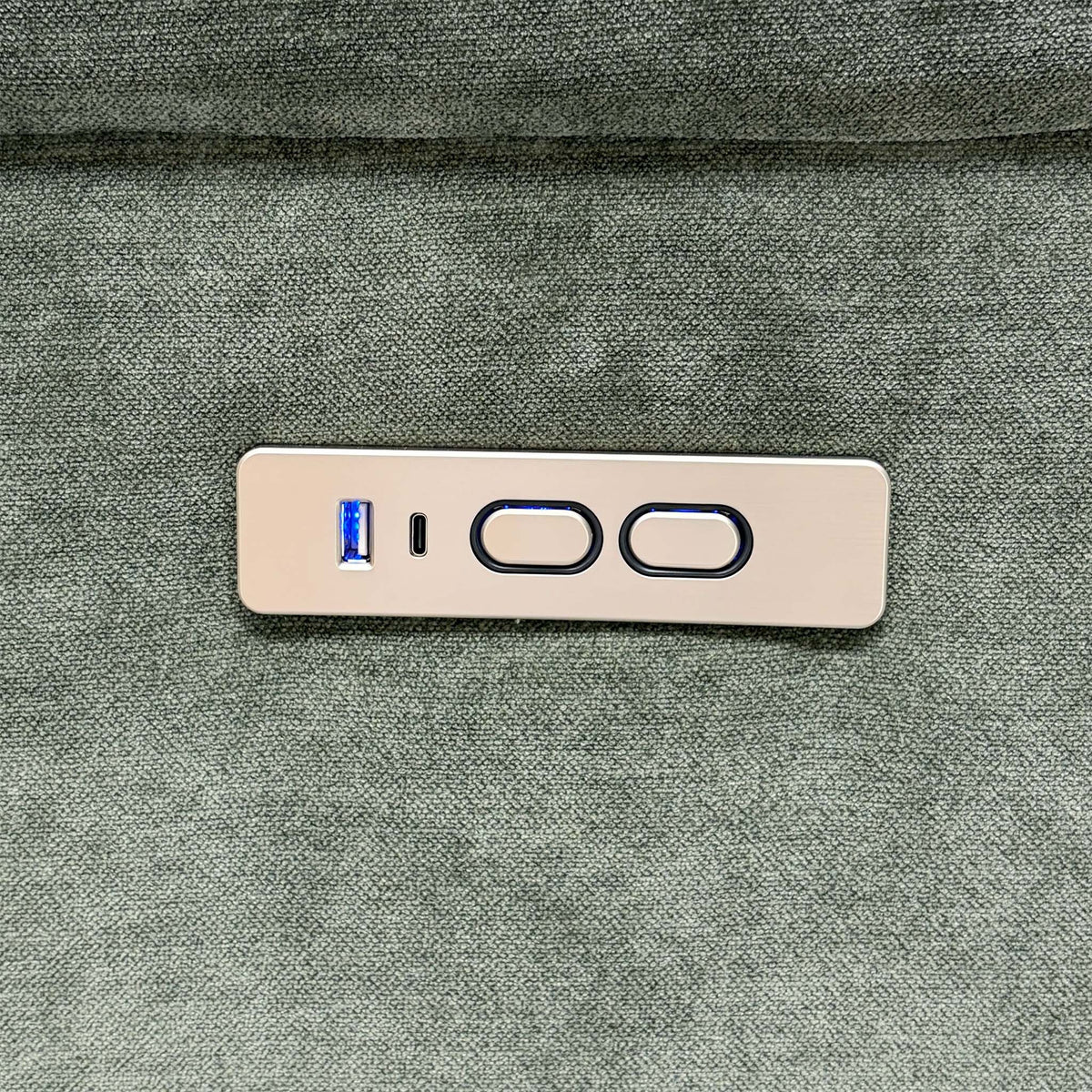 Close-up of the Berlin forest green recliner sofa power control panel with USB ports and two buttons