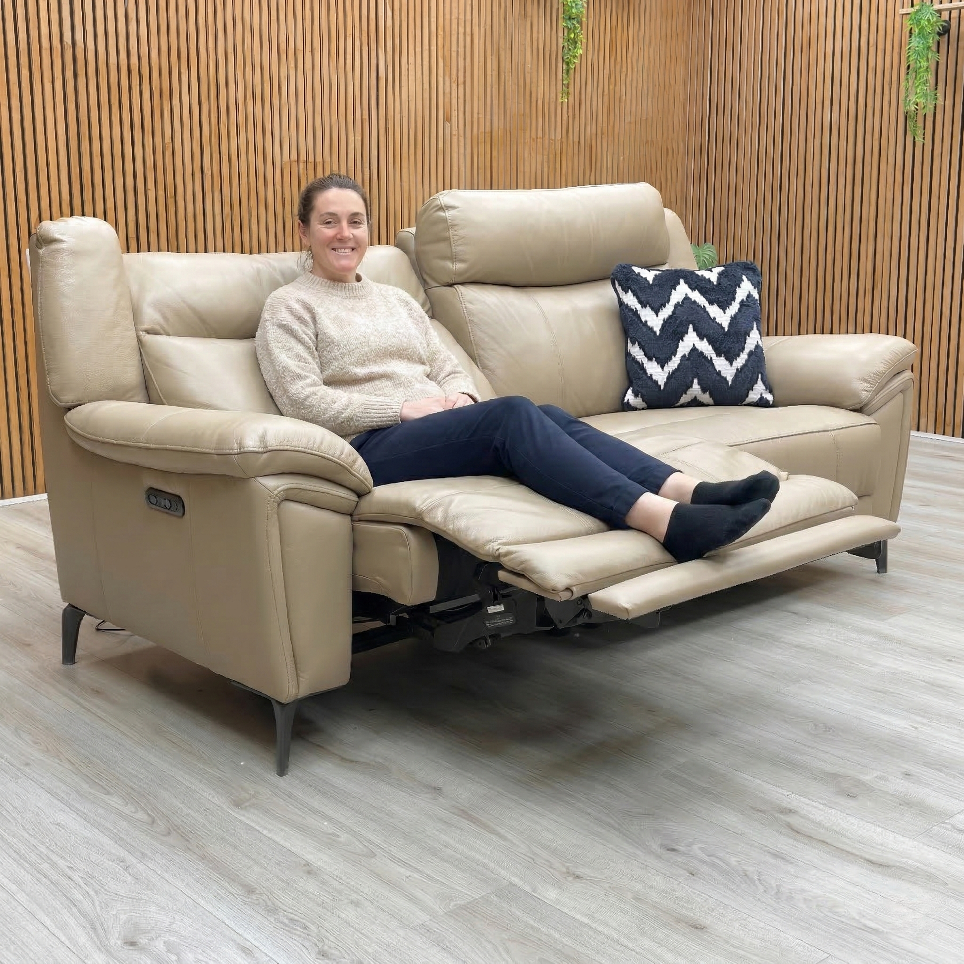 Lifestyle shot of the Panache 3 seater sofa, highlighting its sleek curves, high back, and contemporary metal legs.