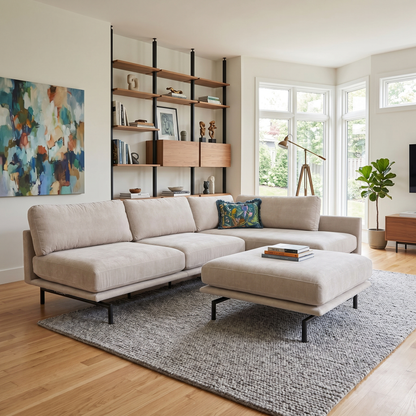 Living room shot of the Brixton Chaise and Footstool, highlighting the neutral taupe upholstery and modern block feet.