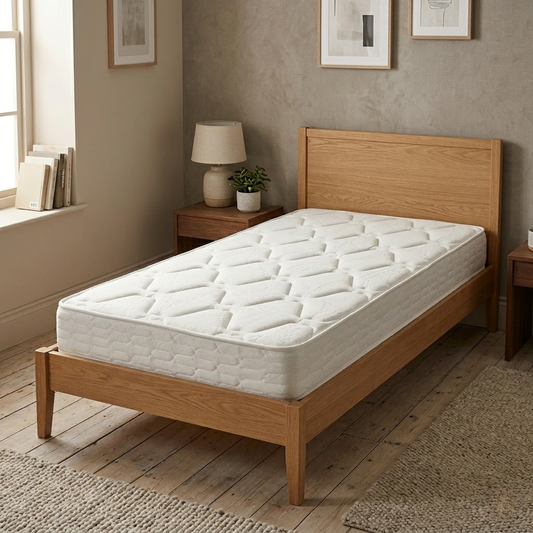bedroom view of the Garda single mattress placed on a wooden bed frame, showcasing its 28 cm profile.