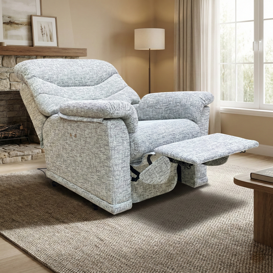 Living room of the G Plan Malvern armchair, highlighting the textured grey woven fabric and ergonomic lumbar support cushioning.