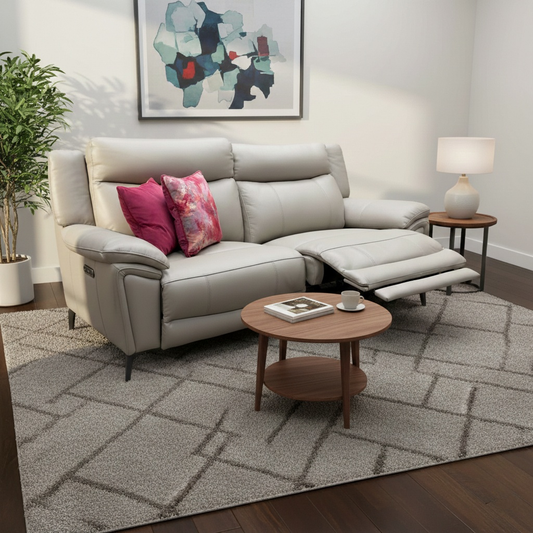 Living room of the 'Panache' leather sofa, showcasing its luxurious curves and metal leg base.