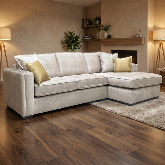 Lifestyle view of the large Chelsea corner chaise in a modern living room, highlighting the soft sheen of the beige Vogue velvet and its contemporary silhouette.