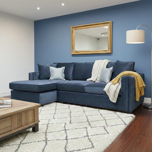 Lifestyle shot of the Chelsea Meridian Truffle soft weave corner chaise in a bright living room setting, highlighting its contemporary aesthetic and generous seating.