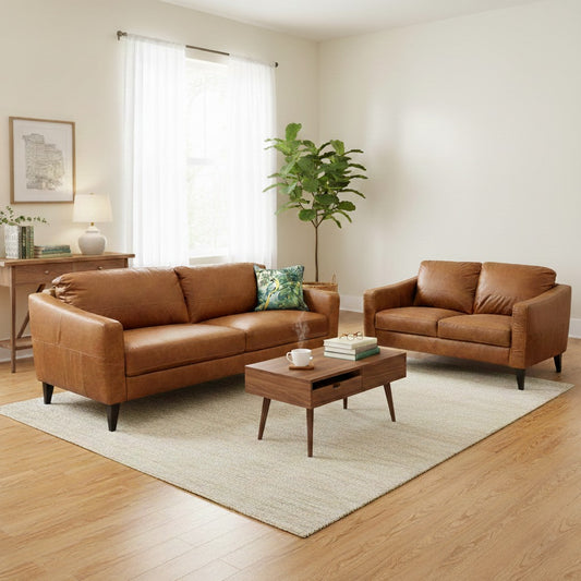 Living Room shot of the ‘Oslo’ sofa set, highlighting the rich texture of the distressed leather and the warm natural tones of the teak wood frame.