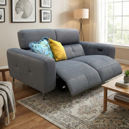 Lifestyle photograph of the 'Ezra' 2-seater sofa in a home setting, highlighting the luxurious velvet texture and sophisticated grey color palette.