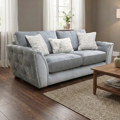 Living room of showing the elegant curved arms and button detailing of the 'Aphrodite' sofa.