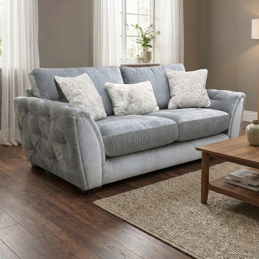 Living room of showing the elegant curved arms and button detailing of the 'Aphrodite' sofa.