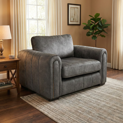 Living Room shot of the ‘Amara’ charcoal velvet chair, highlighting its compact and inviting silhouette for two.