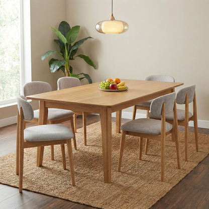 Dining Room view of a Stockholm dining chair highlighting the curved ergonomic backrest and light oak finish.