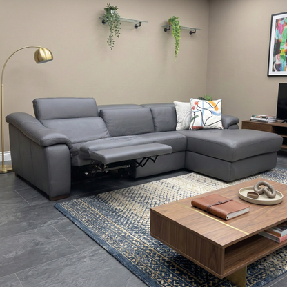 Living room view of the Galileo sofa in Torello Blu leather, showcasing the spacious chaise end, deep bucket seating, and contemporary low-profile aesthetic.