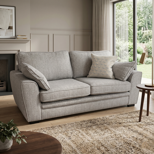 Living room view of the Chalfont Grey sofa, showcasing the symmetrical two-over-two cushion design and the spacious seating area for three people.