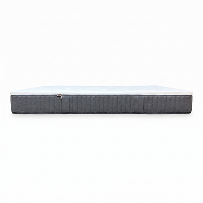 Side view of the Emma Original king-size mattress styled on a modern low-profile wooden bed frame in a bright, minimalist bedroom setting.