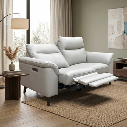 Living room of the Oslo sofa, highlighting the padded wrap-around armrests and the premium light grey leather upholstery.