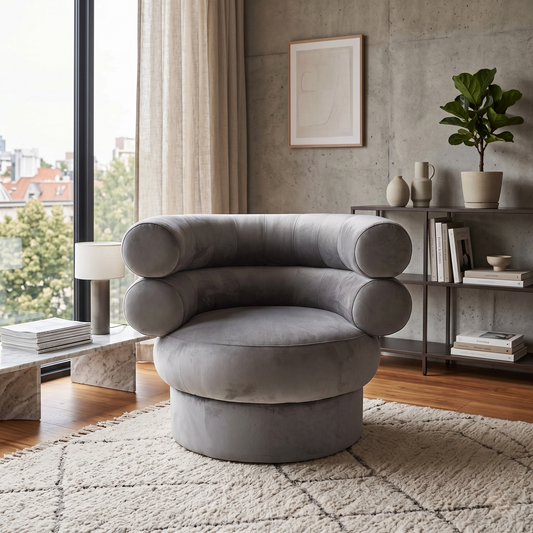 Living room shot of the Fitzrovia accent chair, showcasing the rich texture of the charcoal grey velvet and its sophisticated boutique hotel aesthetic.