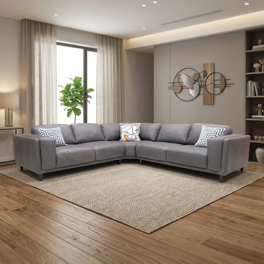 Living room view of the Brody Grey Leather Corner Sofa, showcasing the spacious five-seat configuration and contemporary low-back silhouette.