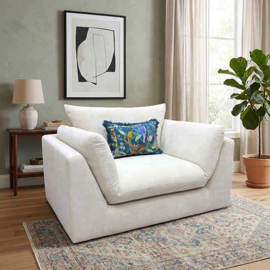 Living Room DFS ‘Kalista’ snuggle cuddler chair, featuring an oversized curved frame fully upholstered in premium cream Palmero plain velvet fabric.