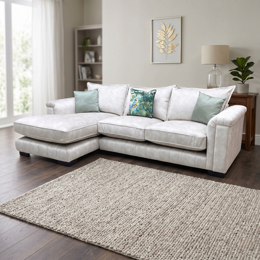 Living Room view of the cream Dolcie chaise lounge sofa, showcasing its expansive seating layout, deep cushioning, and plush padded armrests.