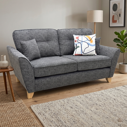Lifestyle view for the ‘Halstow’ Charcoal fabric 2-seater sofa, highlighting its spacesaver compact design, premium textured weave upholstery, and modern apartment aesthetic.