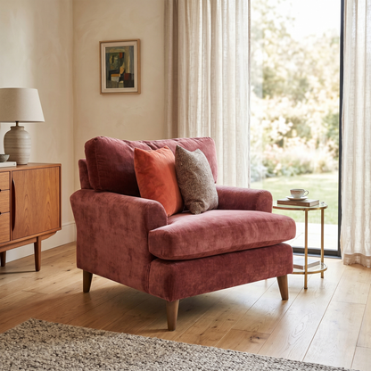 Living room view for the ‘Jackson’ Paprika Red fabric armchair, highlighting its bold statement upholstery, medium comfort support, and sturdy modern block feet.