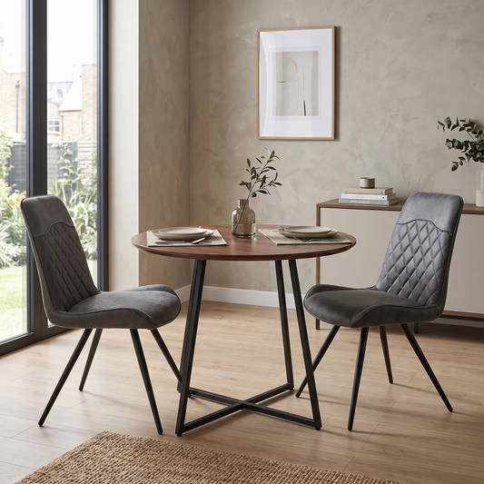 Dining room view of the ‘Warrior’ cantilever chair, emphasizing the comfortable deeply padded seat cushion and the bold contrast between the charcoal grey upholstery and dark frame.