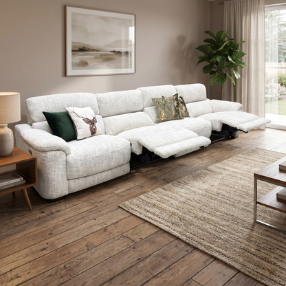 Living room of the Nova beige fabric XL 4-seater sofa fully reclined, demonstrating the dual electric footrests extended for premium lounging comfort.