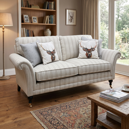 Living room view of three-quarter angled view of the Parker Knoll Burghley fabric sofa, highlighting the deep seat cushions, traditional silhouettes, and fine tailored piping details.