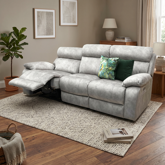 Living room view of the Moreno grey fabric 3-seater sofa fully reclined with power headrests adjusted, demonstrating smooth independent electronic controls for customized lounging comfort.