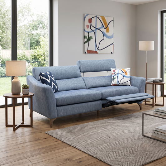 Styled upscale contemporary living room lifestyle layout featuring the Moderna Marine Blue fabric 3-seater power recliner sofa arranged as an inviting home theater centerpiece.