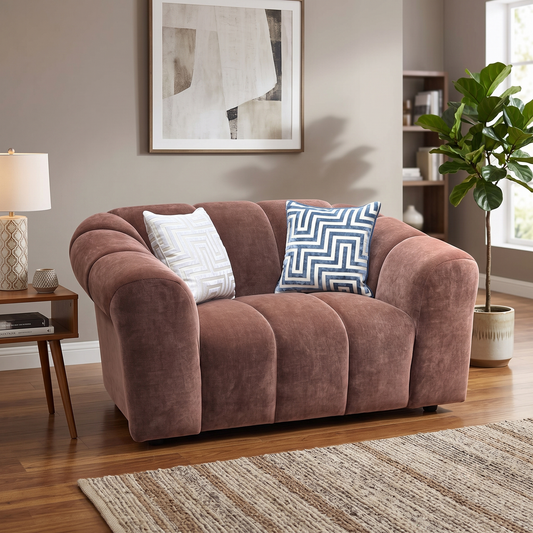 Styled upscale contemporary living room alcove or reading nook layout featuring the Rhianna burnt sienna orange fabric cuddler chair arranged as a bold, cozy statement centerpiece.