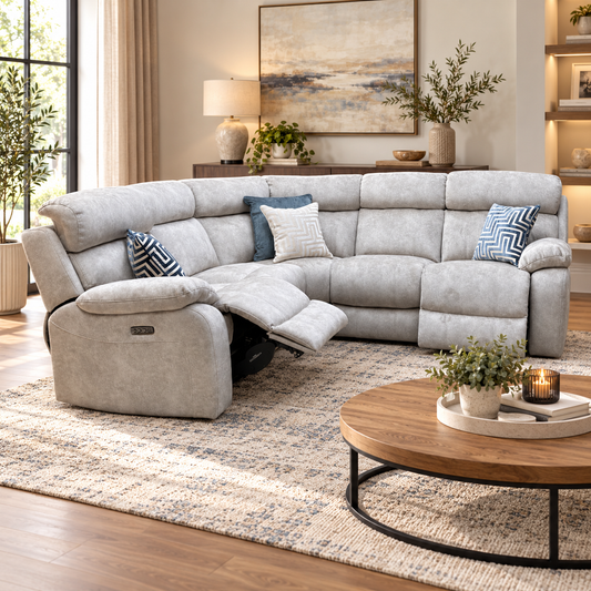 Moreno cream fabric power recliner corner sofa in a living room with a round wooden coffee table and rug