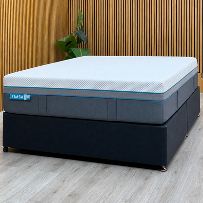 Simba Ultra Hybrid 7300 king mattress on a dark grey divan base against a slatted wood wall