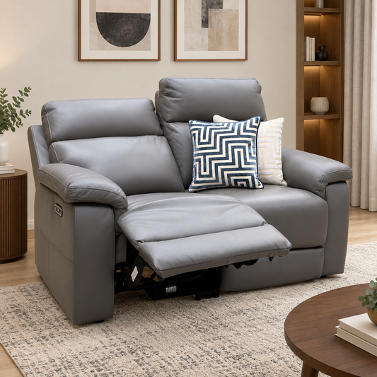 Raven elephant grey leather 2 seater power recliner sofa in a living room with one seat reclined on a patterned rug