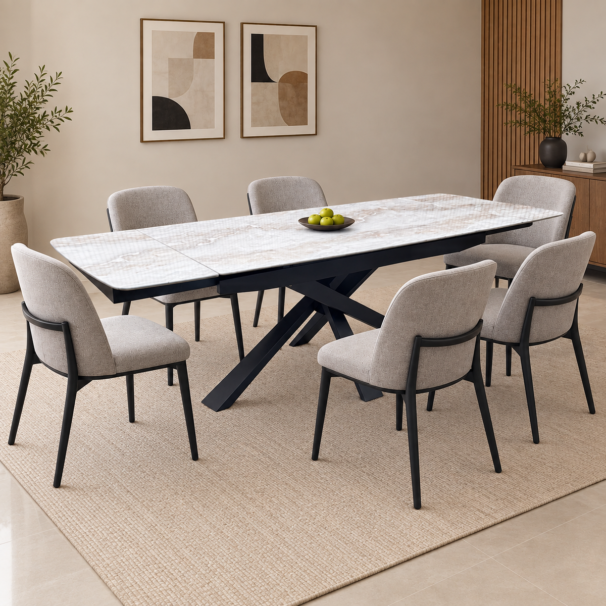 Germain real marble top extending dining table in a dining room with six grey chairs and a bowl of fruit