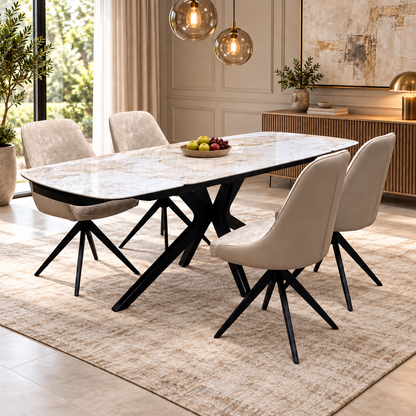 Jose Calcatta marble dining table and four cream chairs in a dining room with a fruit bowl and pendant lights