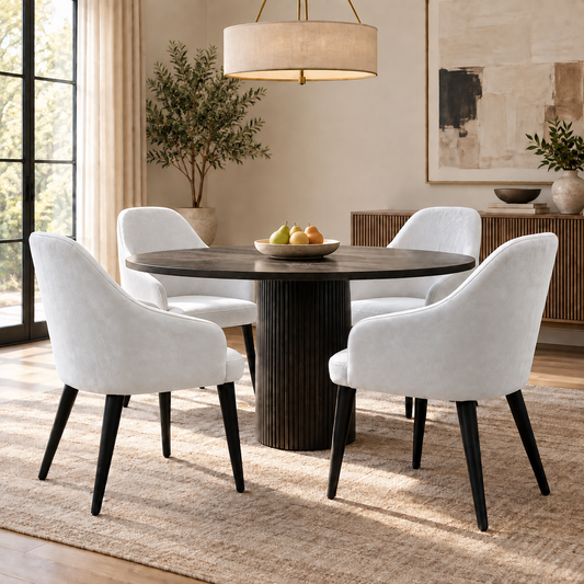 Blade white suede fabric dining chairs around a round dark wood dining table in a dining room