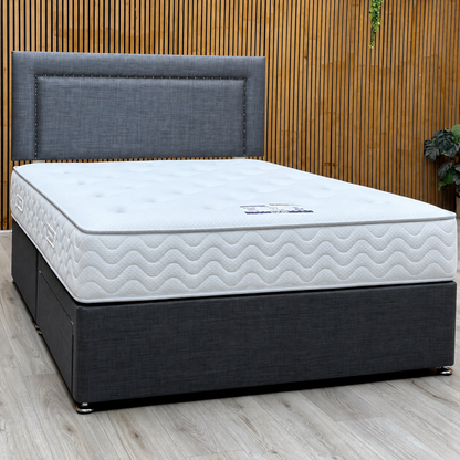 George grey fabric strutted headboard, divan base and Lullaby pocket mattress against a slatted wooden wall