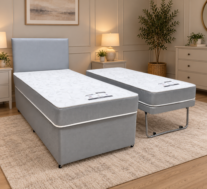 Gus grey fabric single guest bed in a bedroom with the pull-out bed set up alongside, bedside lamps and rug