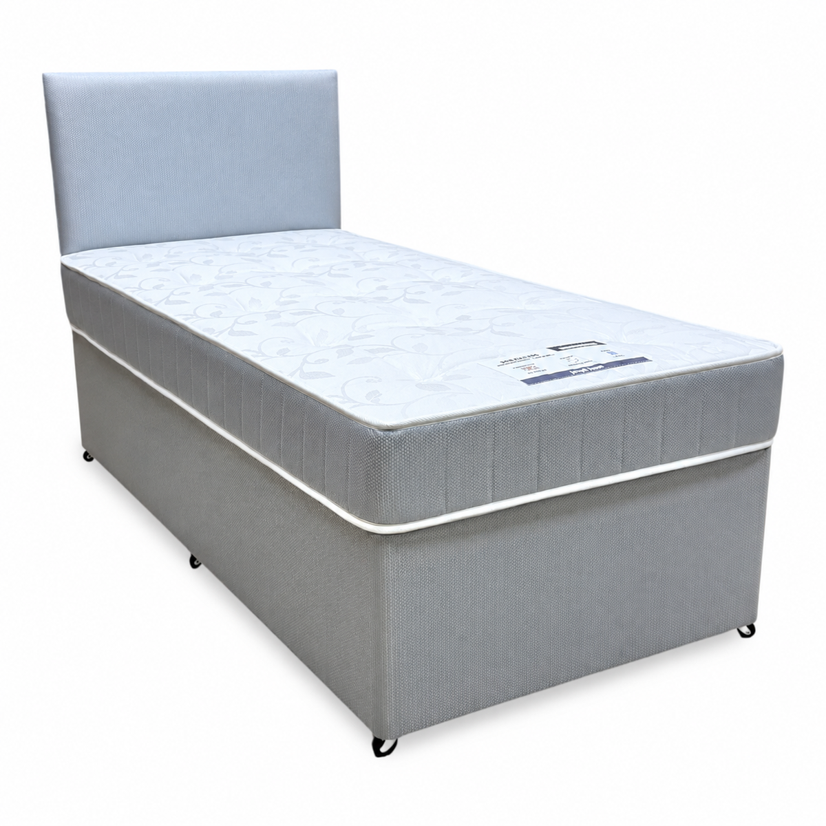 Gus grey fabric single guest bed with headboard, angled view from the side without the pull-out drawer showing