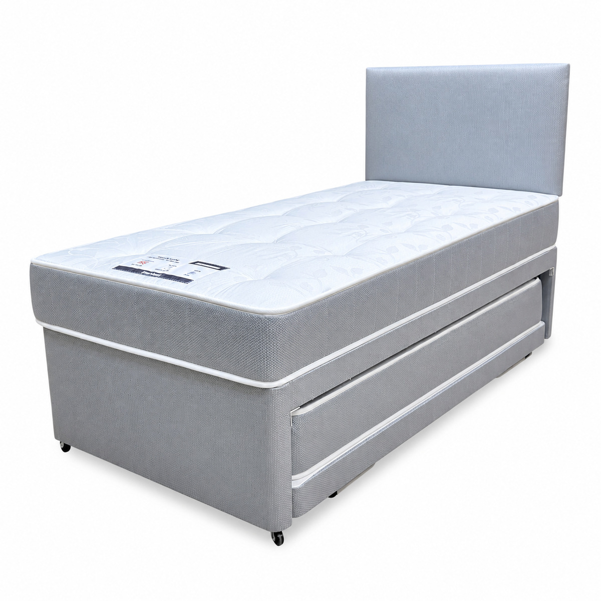 Gus grey fabric single guest bed, angled view showing the pull-out trundle drawer closed under the divan