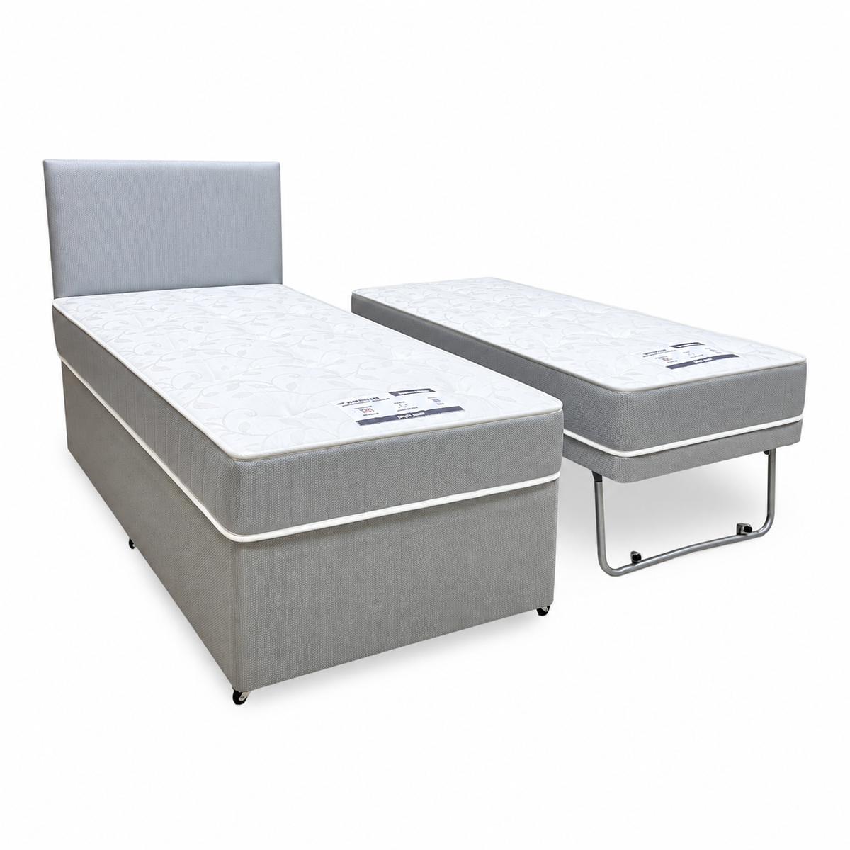 Gus grey fabric single guest bed with the pull-out bed raised on folding legs beside it, angled view
