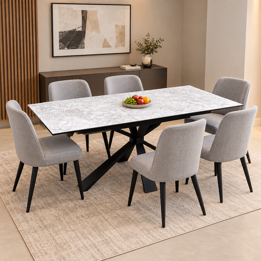 Crete white ceramic extending dining table in a dining room with six grey fabric chairs and a bowl of fruit
